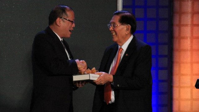 FIRST COPY: Senate President Juan Ponce Enrile gives President Aquino a copy of his memoir (Photo by Fung Yu)