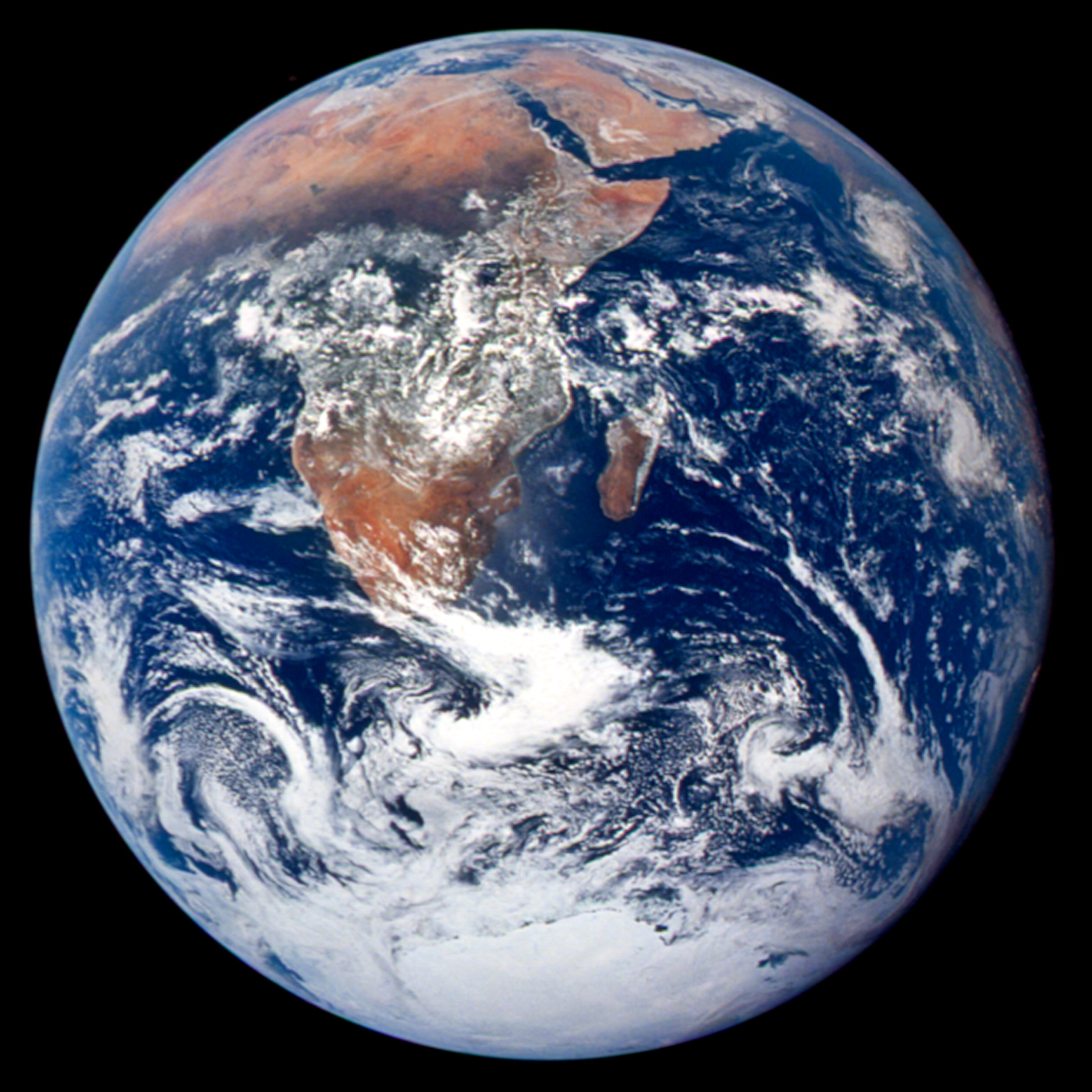 BLUE MARBLE 1972. This classic photograph of the Earth was taken on December 7, 1972. The original caption is reprinted below:  View of the Earth as seen by the Apollo 17 crew traveling toward the moon. This translunar coast photograph extends from the Mediterranean Sea area to the Antarctica south polar ice cap. This is the first time the Apollo trajectory made it possible to photograph the south polar ice cap. Note the heavy cloud cover in the Southern Hemisphere. Almost the entire coastline of Africa is clearly visible. The Arabian Peninsula can be seen at the northeastern edge of Africa. The large island off the east coast of Africa is the Republic of Madagascar. The Asian mainland is on the horizon toward the northeast. Astronaut photograph AS17-148-22727 courtesy NASA Johnson Space Center Gateway to Astronaut Photography of Earth