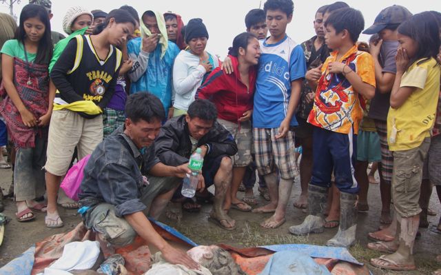 DEADLY TYPHOON. Dead bodies of typhoon victims lined up in Compostela Valley. Photo by Karlos Manlupig 