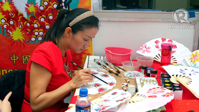 SUBTLE SKILL. Fan painting is demonstrated in the atrium of Lucky Chinatown Mall