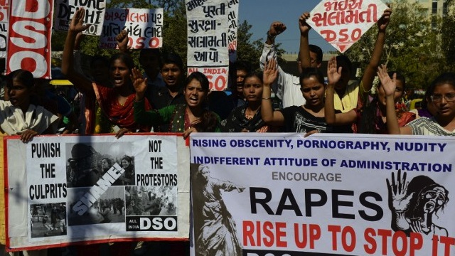 'STOP THE RAPES' Members from The All India Democratic Students' Organization hold posters as they take part in a protest in Ahmedabad on December 24, 2012, following the gang rape of a student last week in the Indian capital. AFP PHOTO / Sam PANTHAKY