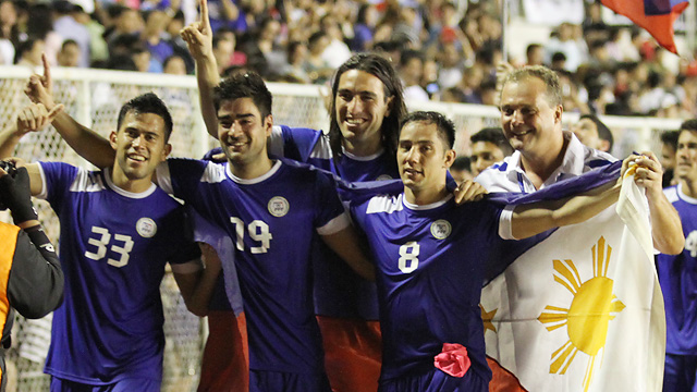 VICTORY. Azkals coach Michael Weiss and several players pose after their 1-0 win over Turkmenistan. Photo by Josh Albelda/RAPPLER