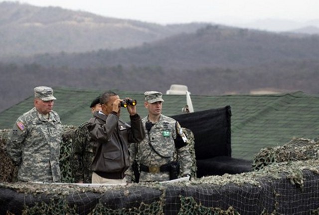 CHECKING. US President Barack Obama (2nd L) looks through binoculars towards North Korea from Observation Post Ouellette during a visit to the Joint Security Area of the Demilitarized Zone (DMZ) near Panmunjom on the border between North and South Korea on March 25, 2012. Obama arrived in Seoul earlier in the day to attend the 2012 Seoul Nuclear Security Summit to be held on March 26-27. Photo by AFP
