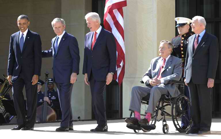 US President Barack Obama (L) and former presidents (L-R) George W. Bush, Bill Clinton, George H.W. Bush and Jimmy Carter arrive on stage for the George W. Bush Presidential Center dedication ceremony in Dallas, Texas. AFP PHOTO/Jewel Samad