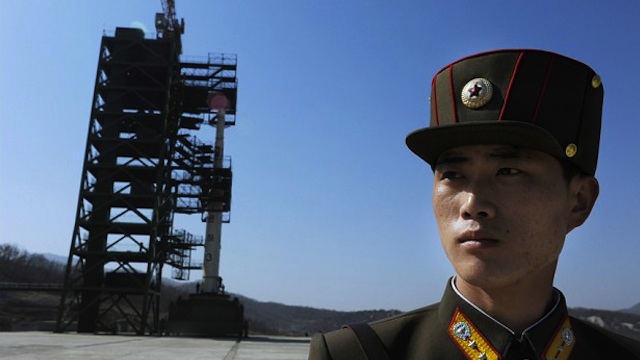 READY FOR LIFTOFF. A North Korean soldier stands guard in front of an Unha-3 rocket at Tangachai -ri space center on April 8, 2012. North Korea has confirmed their intention to launch the rocket this week (between April 12-16) despite international condemnations. AFP Photo/Pedro Ugarte