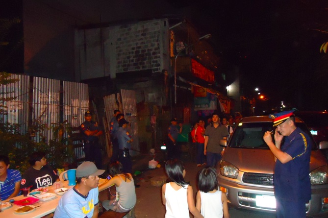 NOTHING UNUSUAL? Cops turn up at the opposition's barangay event in Binondo, Manila on February 27. Photo by Jerald Uy