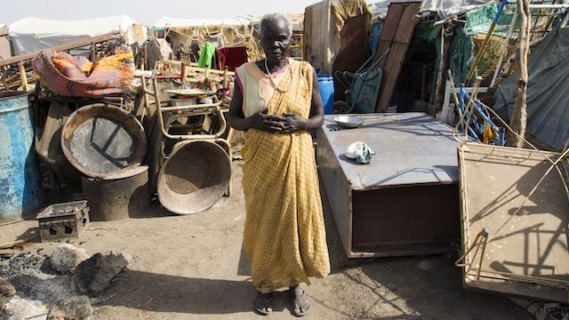DISPLACED. A woman stands among her belongings at Payeur transit site in Renk, in South Sudan’s Upper Nile State, 24 April 2013. Photo by Martine Perret/UN Photo