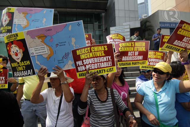 'NO TO CHINA INCENTIVES.' Party-list group Akbayan stages a rally in front of the Chinese consulate in Makati City on March 3, 2014 to protest the so-called water cannon incident involving Chinese government ships in the disputed West Philippine Sea (South China Sea). Photo by Jose Del/Rappler