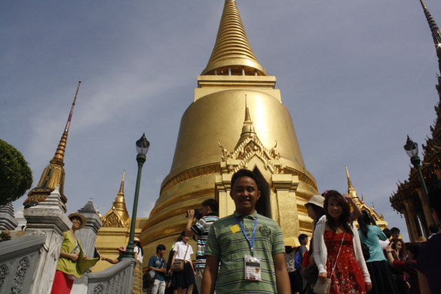 GRAND, INDEED. The structure at the back is one of the gold-plated temples inside the Grand Palace