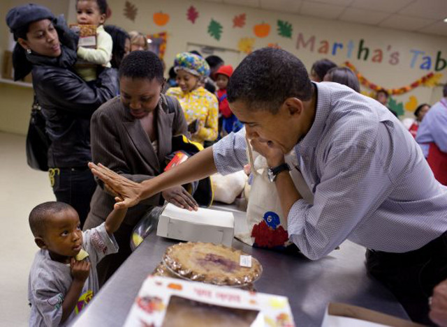 HIGH FIVE! US President Barack Obama exchanges good vibe with a tiny constituent on January 19, the National Day of Service. Photo from the Barack Obama Facebook page