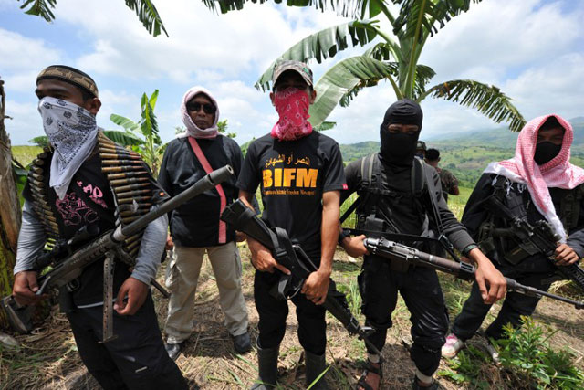 BREAKAWAY GROUP. Bangsamoro Islamic Freedom Fighters (BIFF) standing guard during a clandestine press conference at Camp Omar, in the town of Datu Unsay in Maguindanao. August 2011. File photo by Ted Aljibe/AFP