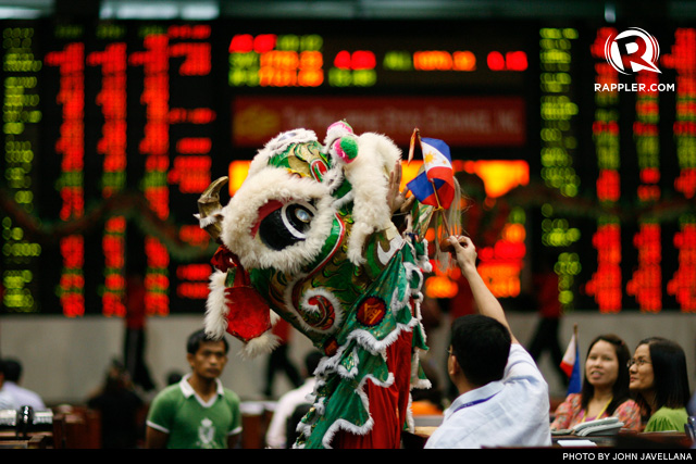 LUCK IN RETURN FOR BLESSINGS. A Dragon Lion performer reaches for an 'ampao' inside the Philippine Stock Exchange in Makati City. Photo dated February 7, 2008