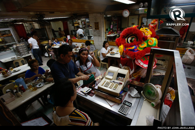 DANCING FOR 'AMPAO.' A Dragon Lion dances and goes around inside a Chinatown restaurant