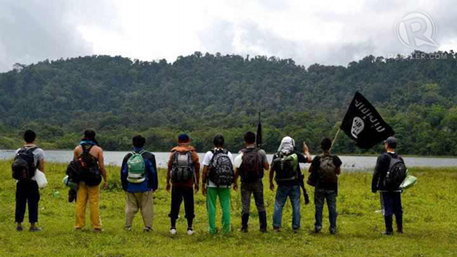 BLACK FLAG. Filipinos carry the black flag in southern Philippines. It symbolizes the apocalypse that would bring about the triumph of Islam. File photo