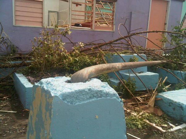 SCHOOL DAMAGED. Secretary Roxas snaps a photo of the damage Pablo brought to an elementary school. 