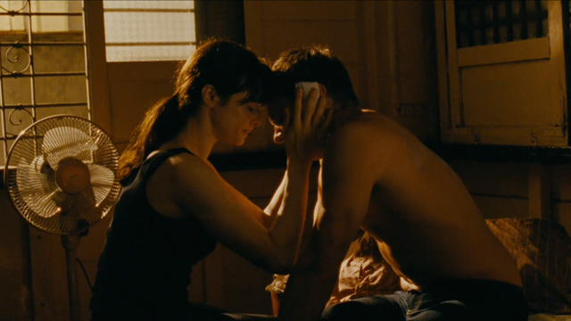 Renner and Weisz get intimate in what looks like a traditional Filipino house adorned with sliding windows made of corales