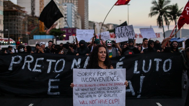 'NO WORLD CUP.' Demonstrators take part in a national protest against the upcoming FIFA World Cup Brazil 2014 in Rio de Janeiro, Brazil, 25 January 2014. Photo by Antonio Lacerda/EPA