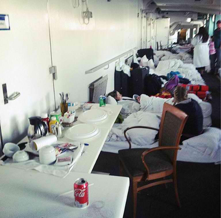 CAMPING OUT. An Instagram photo provided by a passenger of the Carnival Cruise Ship Triumph identifying herself as Chasemaclaskey shows passengers sleeping on the deck of the ship as it is towed by tug vessels toward Mobile, Alabama, on February 13, 2013.  AFP PHOTO / Chasemaclaskey