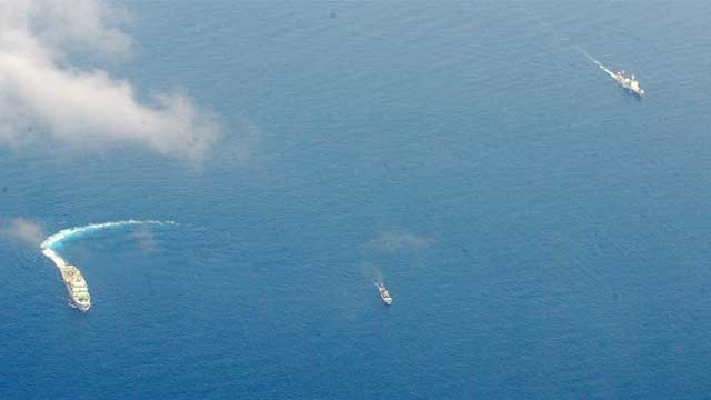 DAVID VS GOLIATH. A much smaller Philippine ship arrives at the disputed Ayungin Shoal. Photo by AFP