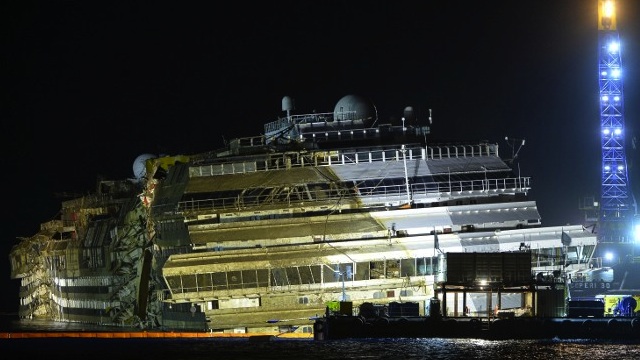 OUT OF THE WATER. The wreck of Italy's Costa Concordia cruise ship emerges from water at the tail-end of the salvage operations for the ship, September 17, 2013 near the harbor of Giglio Porto. AFP / Andreas Solaro