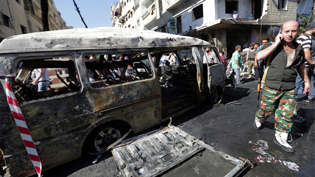 SYRIA, DAMASCUS : Syrians inspect damage at the site of a car bomb in the mainly Druze and Christian suburb of Jaramana on the southeastern outskirts of the Syrian capital on August 28, 2012. AFP PHOTO/JOSEPH EID