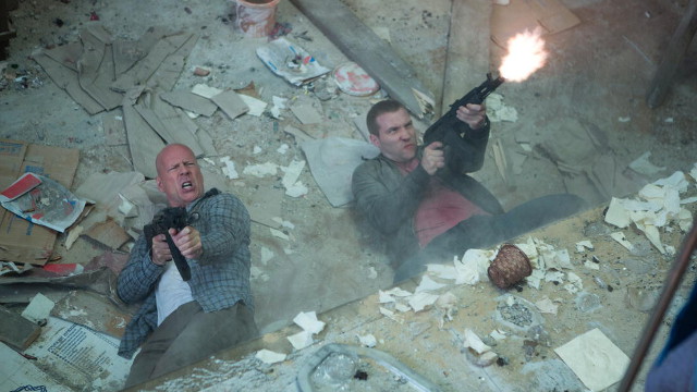 THE FAMILY THAT AIMS TOGETHER. Bruce Willis and Jai Courtney shoot ’em up in 'A Good Day to Die Hard'