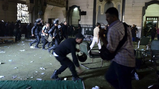 Egyptian riot policemen get in the community services hall of Cairo's Al-Fath mosque where Islamist supporters of ousted president Mohamed Morsi held up on August 17.  Photo by AFP/MOHAMED EL-SHAHED
