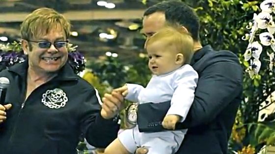 HAPPY DADS, HAPPY BABY. Elton John with David Furnish and Zachary in a video taken at Marina Bay Sands. Screen grab from YouTube (BratPrince84)