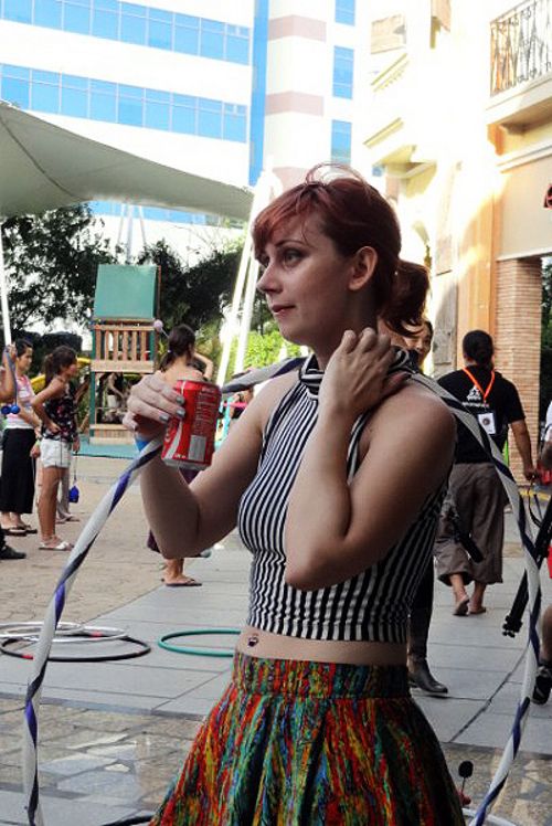 Burlesque fire hooper Justina Flash from the US watches the artists practice