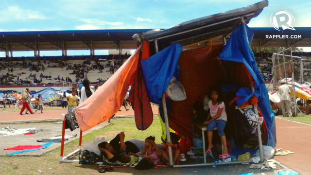 MAKESHIFT HOME. A girl sits under the canopy of her temporary shelter at the Joaquin Enriquez Memorial Grandstand in Zamboanga City on Sept 11, 2013. File photo by Regine Mendoza/Rappler