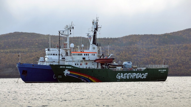 PIRACY? The seized Greenpeace ice breaker 'Arctic Sunrise' (front) is towed by a Russian Coast Guard vessel (behind) along the Kola Bay of the Barents Sea, some 40 kilometers from Murmansk, Russia, 24 September 2013. EPA/Angela Kolyada
