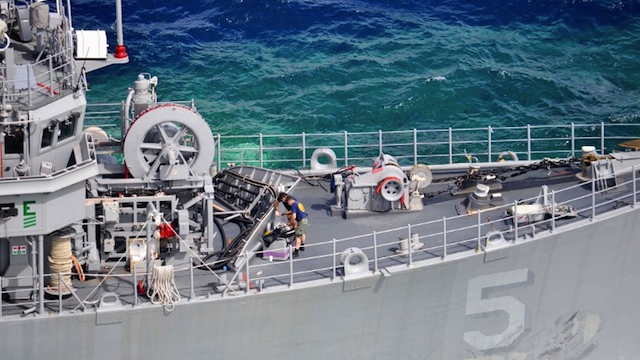 TO BE CUT UP? This January 23, 2013 US Navy handout photo shows members of a US Navy salvage assessment team working aboard the mine countermeasures ship USS Guardian. AFP PHOTO/HANDOUT/US NAVY