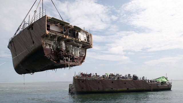 BOW REMOVED. The crane vessel Jascon 25 removes the bow of the USS Guardian, a major step toward pulling out the minesweeper stuck on Tubbataha Reef since January 17. Photo by US Navy