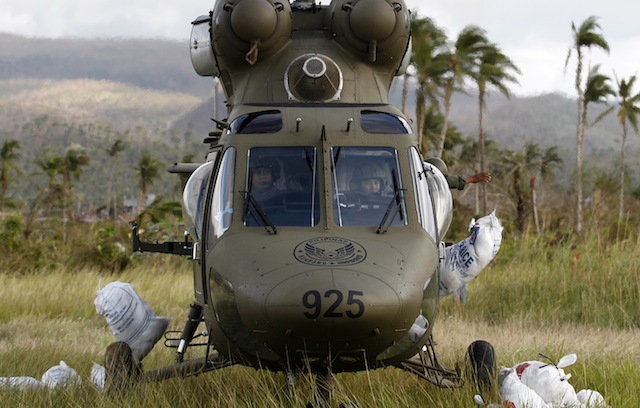 AID FROM THE AIR. Members of the Philippine Air Force Sokol 550th Search and Rescue Group drop sacks of food relief in eastern Samar province, Philippines, 17 November 2013. EPA/Dennis Sabangan