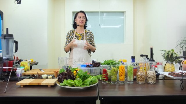 Raw food chef Aileen de Guzman explains the concept of raw foodism to members of the media during the launch of her raw food workshops