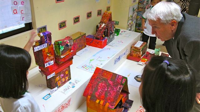 A KINDERGARTNER TALKS ABOUT her social studies project with Dr. Armstrong 