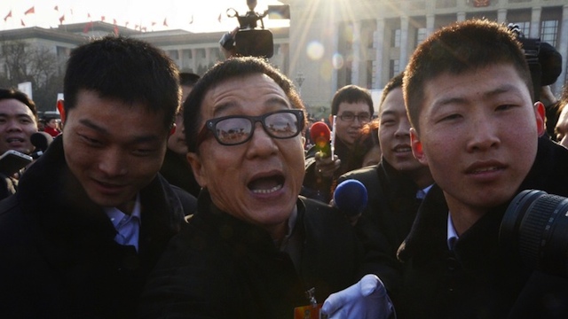 ACTION STAR. Hong Kong movie star Jackie Chan (C) reacts as he leaves the opening session of the Chinese People's Political Consultative Conference (CPPCC) at the Great Hall of the People in Beijing on March 3, 2013. AFP PHOTO/Mark RALSTON ACTION STAR. Hong Kong movie star Jackie Chan (C) reacts as he leaves the opening session of the Chinese People's Political Consultative Conference (CPPCC) at the Great Hall of the People in Beijing on March 3, 2013. AFP PHOTO/Mark RALSTON