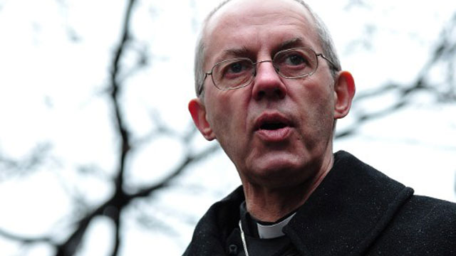LONDON, United Kingdom - Justin Welby, the new Archbishop of Canterbury, says a prayer in the gardens of St Paul's Cathedral in central London on March 16, 2013, as he conducts a 'Journey in Prayers' from the City of London to Southwark Cathedral. The Archbishop has emabrked upon a journey through the city of London, stopping off at various points of significance to offer prayers. AFP PHOTO/CARL COURT