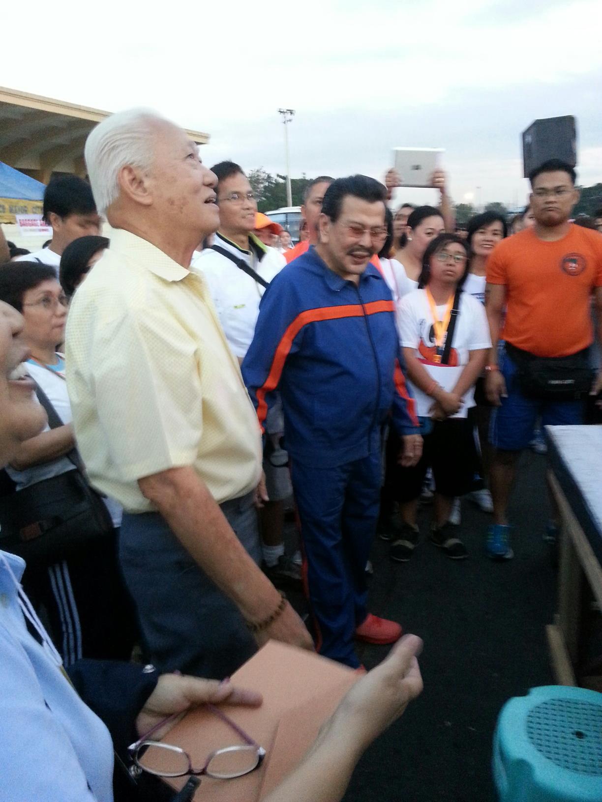 Manila mayoral bets Alfredo Lim (L) and Joseph Estrada (R) share a light moment during a fun run organized by the La Consolacion College in Manila, January 20, 2013. Photo courtesy of the Alfredo Lim campaign.