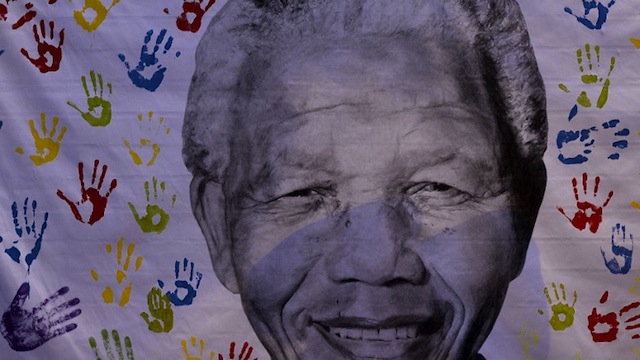 'NOT ILL, JUST OLD.' A picture taken on July 18, 2013 shows a portrait of former South African President Nelson Mandela outside the Medi Clinic Heart Hospital in Pretoria. File photo by AFP / Stephane de Sakutin