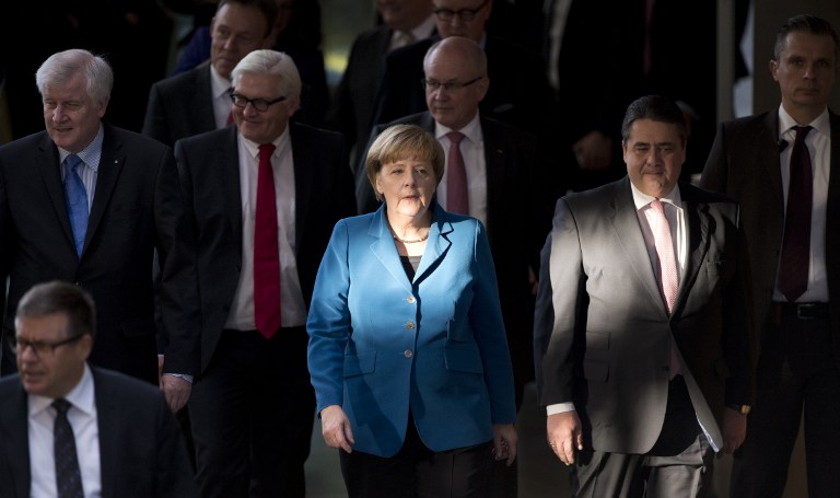 THE CHANCELLOR. In a file photo, German Chancellor Angela Merkel (center), along with other top German officials, arrives for the signing of the new "grand coalition" government agreement at the German Parliament on December 16, 2013. John Macdougall/AFP