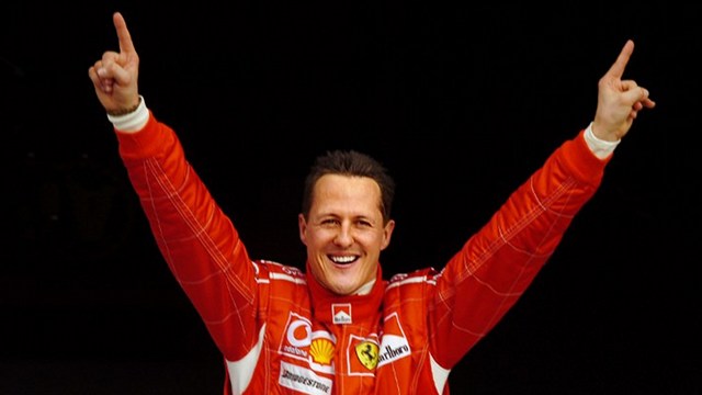 DECORATED CHAMPION. German Ferrari driver Michael Schumacher celebrates after winning the pole position during the qualifying session of the Bahrain Formula One Grand Prix at Sakhir racetrack, 11 March 2006. File photo by Damien Meyer/AFP