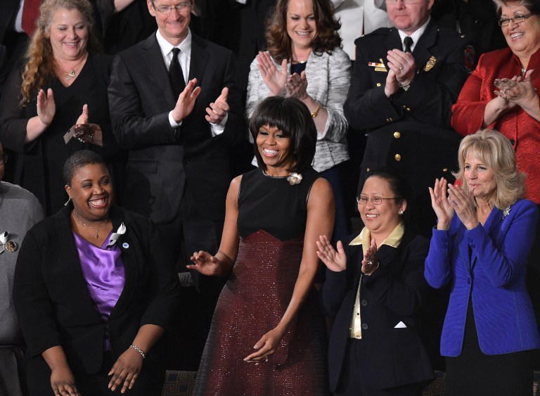 US First Lady Michelle Obama (C) arrives prior to US President Barack Obama's State of the Union address before a joint session of Congress on February 12, 2013 on Capitol Hill in Washington, DC. To her left is nurse Menchu de Luna Sanchez, one of her guests in the First Lady's box at the House gallery. AFP PHOTO / Jewel Samad