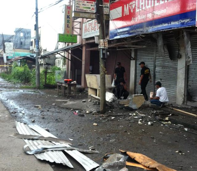 ANOTHER EXPLOSION. Scene of the crime operatives (SOCO) gather pieces of evidence at the site of an explosion in Midsayap, North Cotabato, at the ground floor of a local radio station. Photo courtesy Karl Ballentes