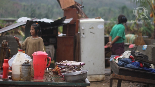 TYPHOON VICTIMS. Compostela residents salvage their belongings amid Pablo's onslaught. Photo by Karlos Manlupig