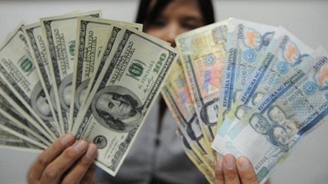 RECOVERING. Personal remittances from overseas Filipinos is starting to pick up after a slowdown in March. Photo by AFP