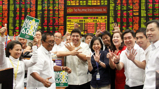FUN AT 6,000. Traders celebrate the new milestone at the local bourse at it breached the 6,000-mark on Monday, January 7. Photo courtesy of the Philippine Stock Exchange.