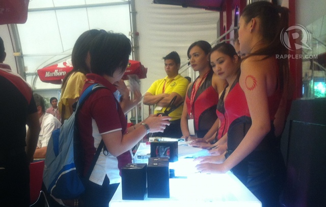 ATTRACTIVE ADVERTISING. In many of the booths, young saleswomen attend to customers. ATTRACTIVE ADVERTISING. In many of the booths, young saleswomen attend to customers.