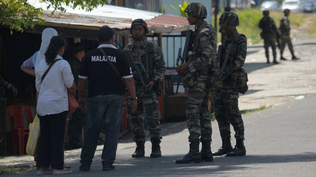Malaysian soldiers man a security check point in Semporna. AFP FILE PHOTO