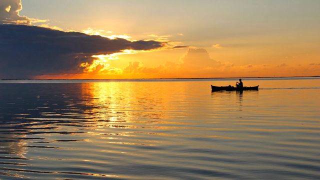 A boat glides on Siargao water